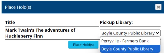 Screenshot of the holds interface showing the header reading "Place Hold(s)". Below that is a listing of the title to be placed on hold (Mark Twain's The Adventures of Huckleberry Finn). To the side of that is the Pickup Library Column, which contains a dropdown listing both "Boyle County Public Library" and "Perryville - Farmers Bank"